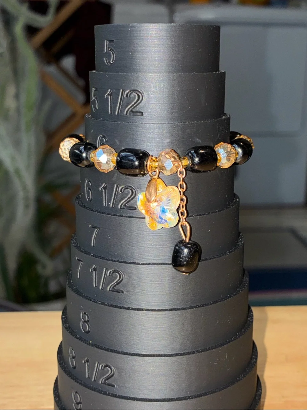 Black and Gold Beaded Stretch Bracelet with Iridescent Flower Charm - Picture 9 of 9